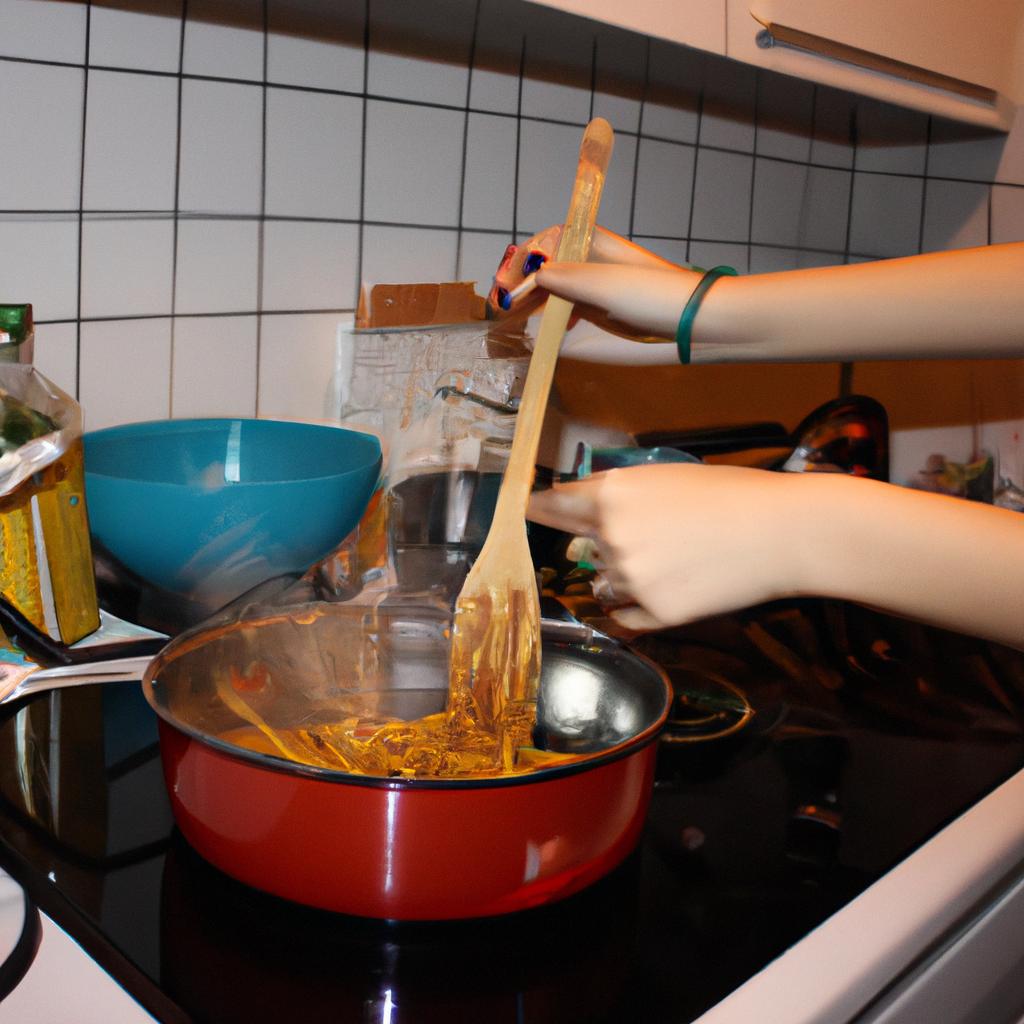Person cooking pasta in kitchen